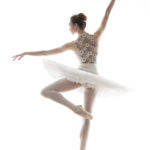silhouette of ballerina in classical tutu in the white studio